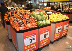 Promotional displays of citrus, melons, and pears.